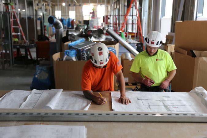 Nickle electricians reviewing blueprints on site