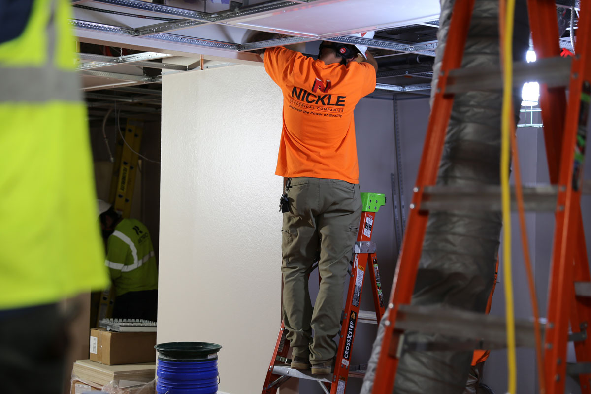 Nickle Electrical technician installing ceiling systems on site
